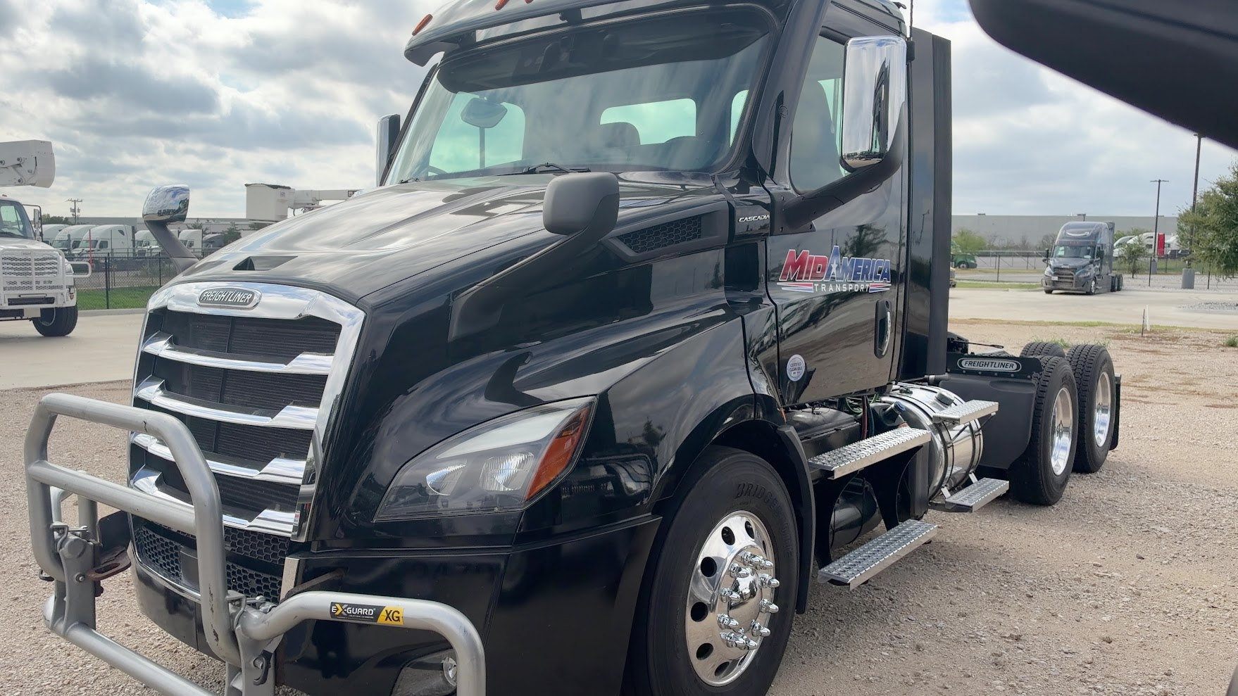 Real MidAmerica Freightliner black tractor grille, bull bar and door branding